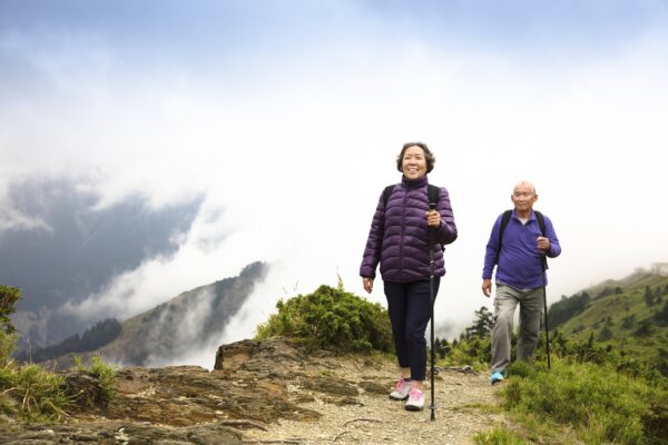 Happy,Asian,Senior,Couple,Hiking,On,The,Mountain