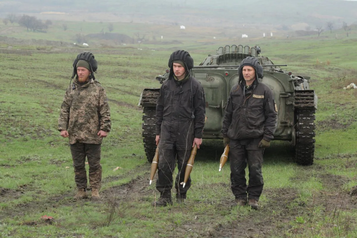 Service members of the Ukrainian armed forces stand next to an armoured vehicle during a training at a firing range in the Donetsk region, Ukraine, on April 20, 2021. (Serhiy Takhmazov/Reuters)