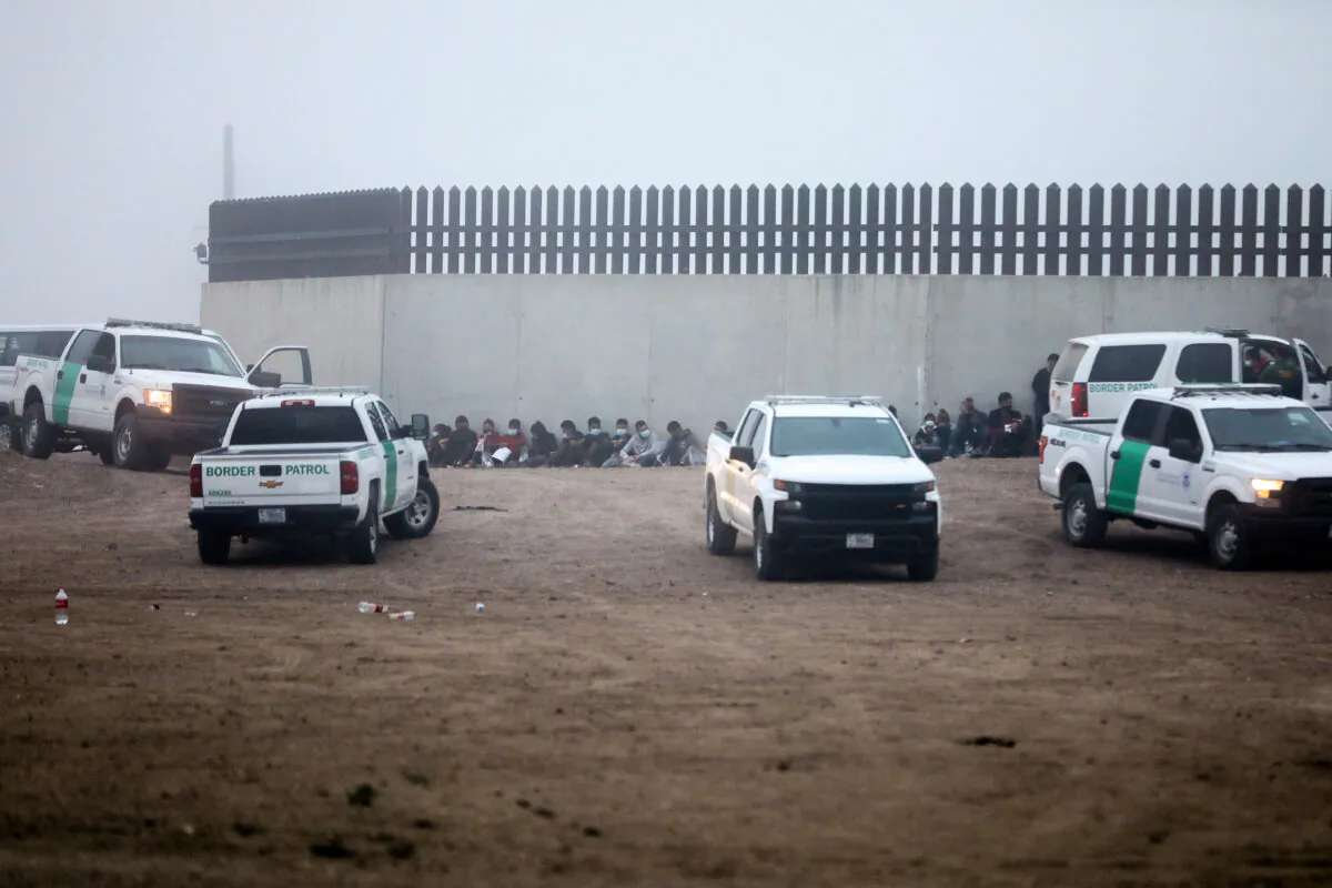 A group of illegal immigrants is processed by Border Patrol after crossing the U.S.-Mexico border in La Joya, Texas, on April 10, 2021. (Charlotte Cuthbertson/The Epoch Times)
