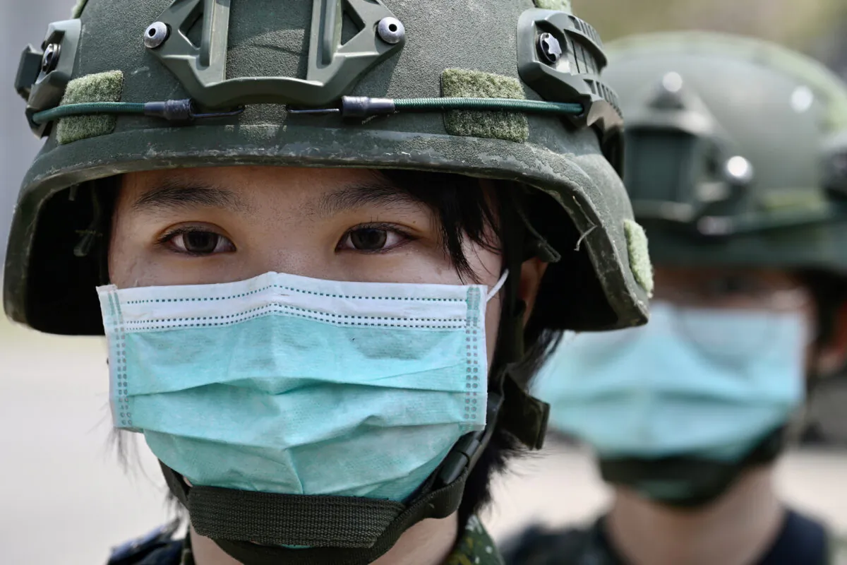 A female soldier stands in formation during Taiwan President Tsai Ing-wen's visit to a military base in Tainan, southern Taiwan, on April 9, 2020. (Sam Yeh/AFP via Getty Images)