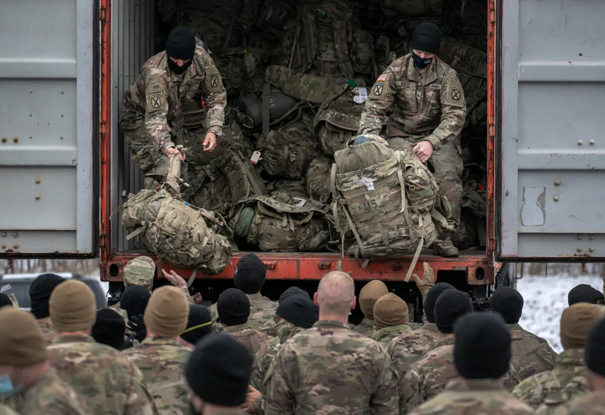 U.S. Army soldiers from the 10th Mountain Division retrieve their duffel bags after they returned home from a 9-month deployment to Afghanistan at Fort Drum, N.Y., on Dec. 10, 2020. (John Moore/Getty Images)