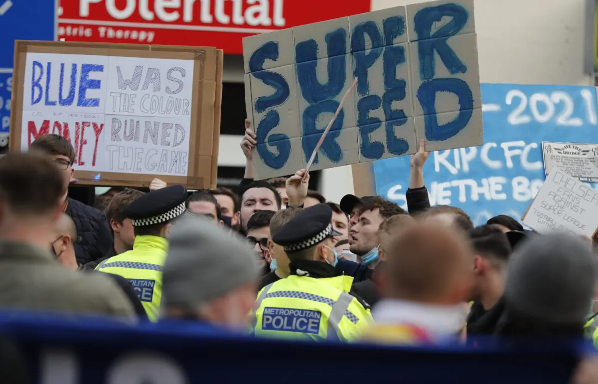 Chelsea fans protest against Chelsea's decision to be included amongst the clubs attempting to form a new European Super League before the English Premier League soccer match between Chelsea and Brighton and Hove Albion outside Stamford Bridge stadium in London, on April 20, 2021. (Frank Augstein/AP Photo)