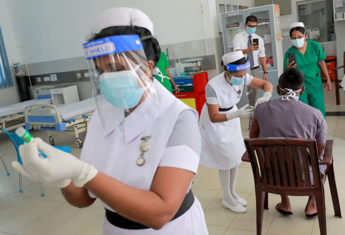 A health official receives a dose of AstraZeneca's COVID-19 vaccine manufactured by the Serum Institute of India, at Infectious Diseases Hospital in Colombo, Sri Lanka, on Jan. 29, 2021. (Dinuka Liyanawatte/Reuters)