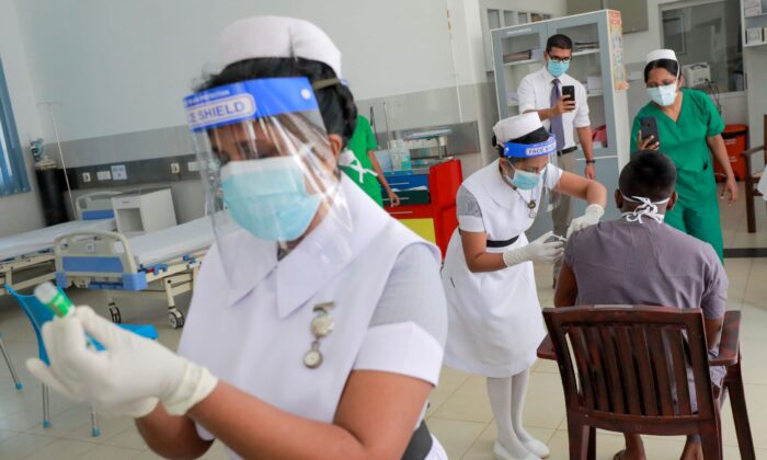 A health official receives a dose of AstraZeneca's COVID-19 vaccine manufactured by the Serum Institute of India, at Infectious Diseases Hospital in Colombo, Sri Lanka, on Jan. 29, 2021. (Dinuka Liyanawatte/Reuters)