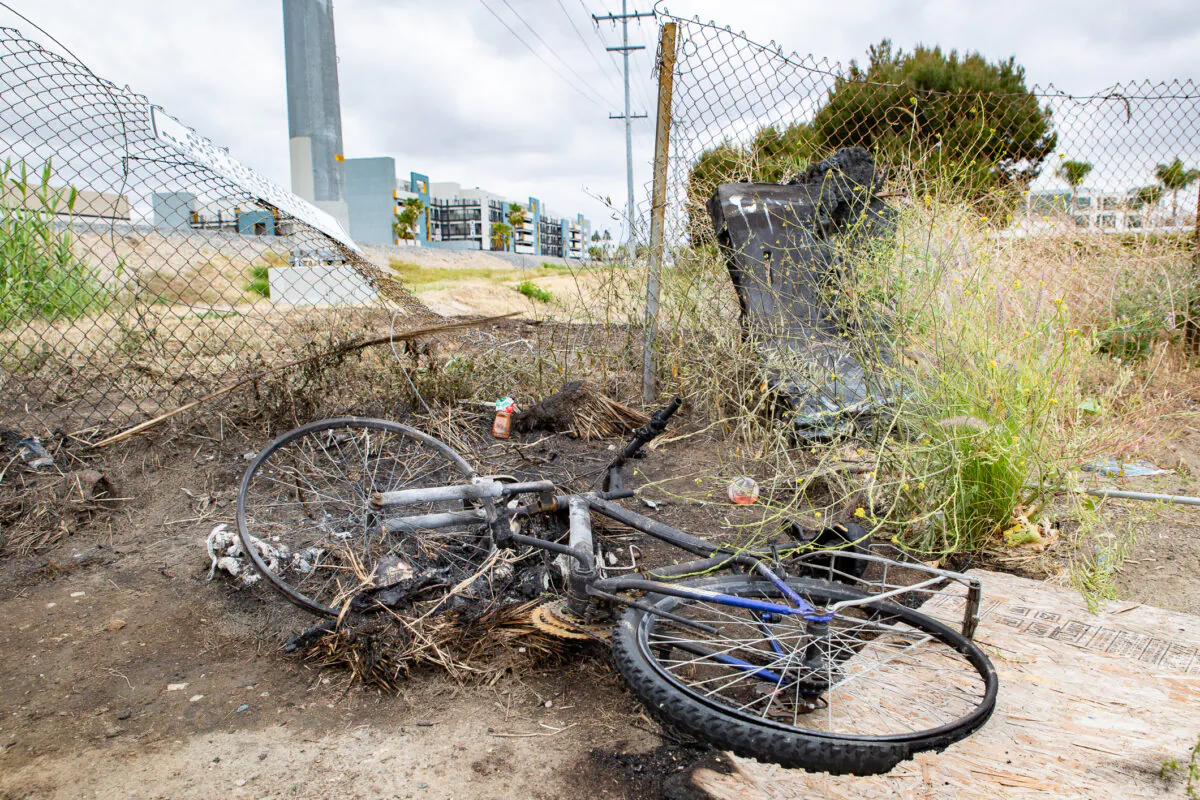 Burned items are found along the 91 freeway April 21, 2021 near the area a homeless man died in an Anaheim, Calif., fire. (John Fredricks/The Epoch Times)