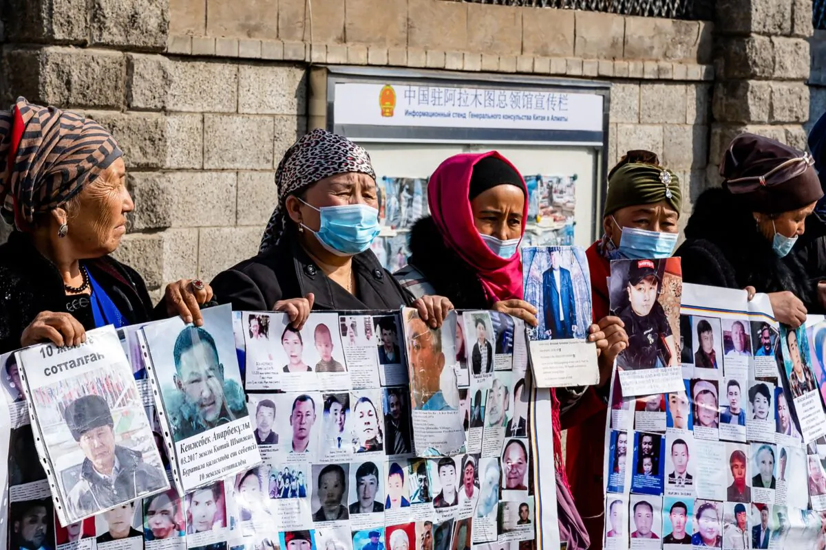 A group of female protestors demand safe passage home for their relatives, who are missing, jailed or trapped in China's Xinjiang region outside the Chinese consulate in Almaty, Kazakhstan on March 9, 2021.  (Abduaziz Madyrovi/AFP via Getty Images)