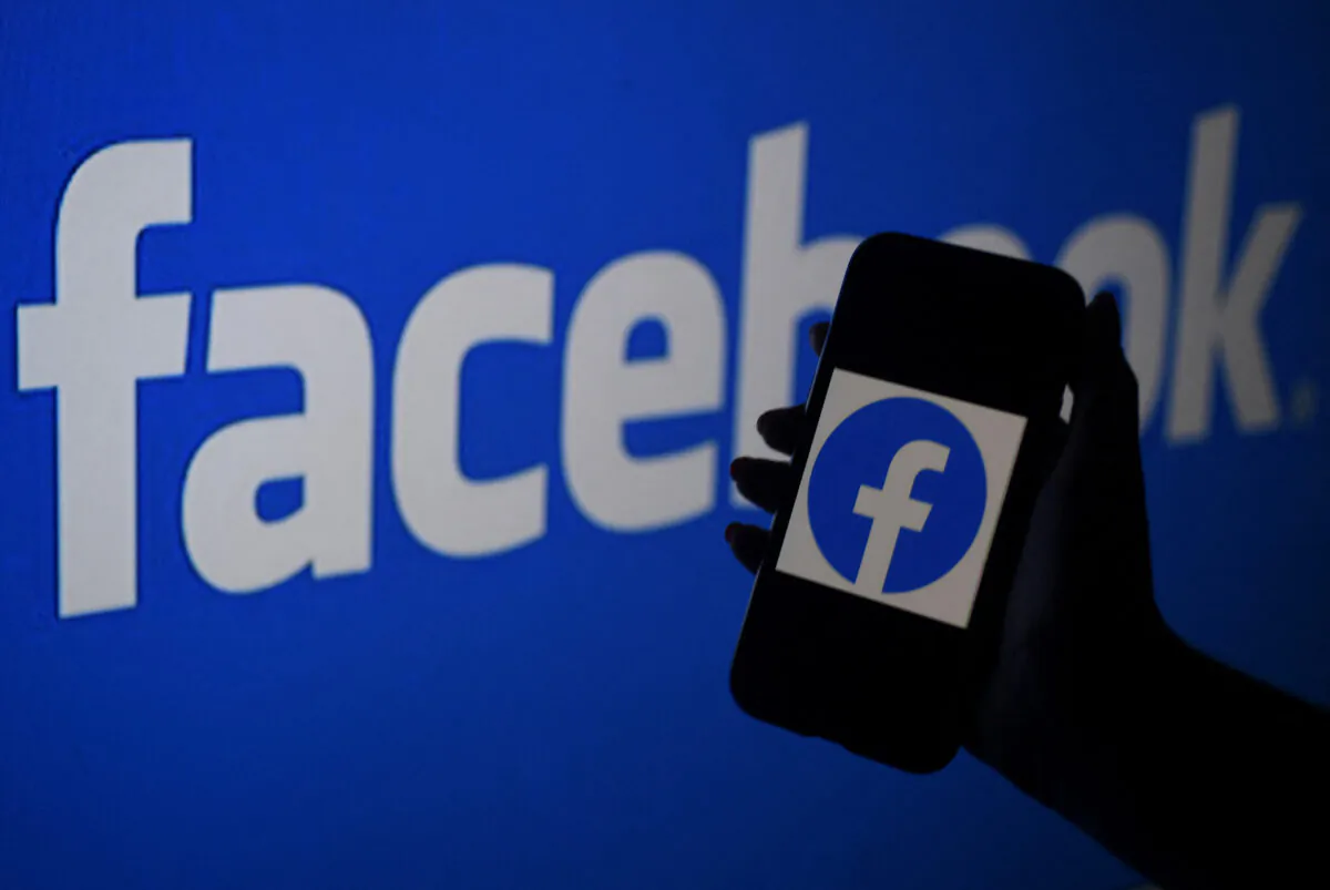 In this photo illustration, a smart phone screen displays the logo of Facebook on a Facebook website background, in Arlington, Va., on April 7, 2021. (Olivier Douliery/AFP via Getty Images)