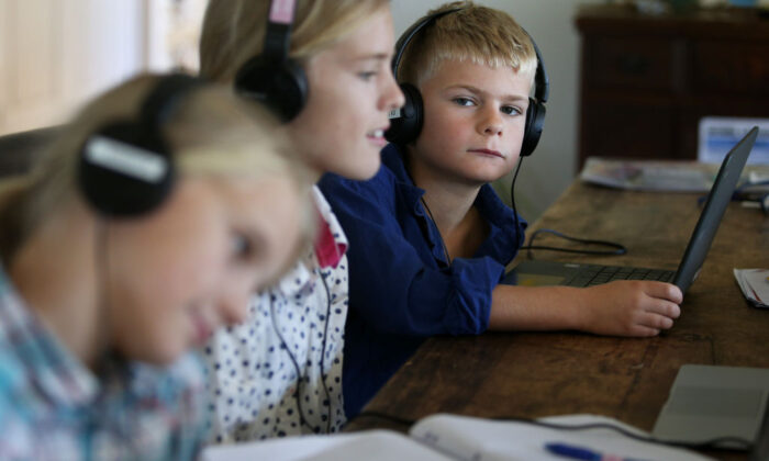 Three children do school work at their family home and cattle property on April 05, 2020 in Tarpoly Creek, Australia. (Lisa Maree Williams/Getty Images)