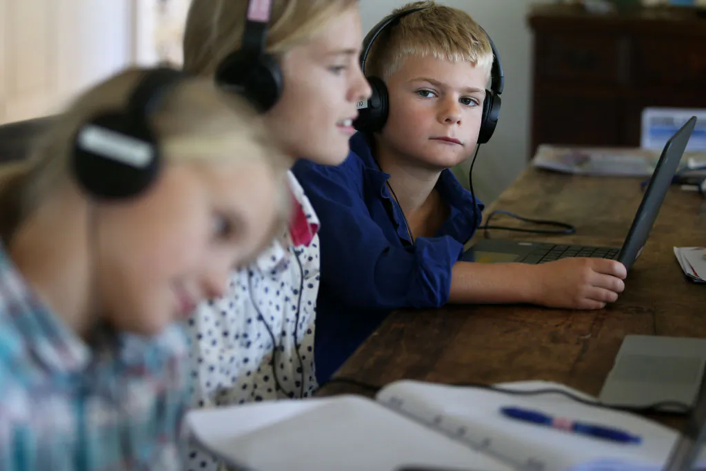 Three children do school work at their family home and cattle property on April 05, 2020 in Tarpoly Creek, Australia. (Lisa Maree Williams/Getty Images)