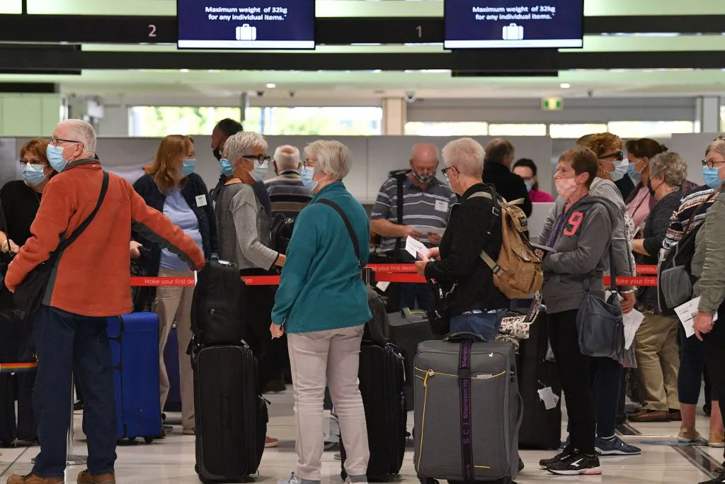 Passengers wait at the check-in counters for New Zealand flights at Sydney International  Airport on April 19, 2021, as Australia and New Zealand opened a trans-Tasman quarantine-free travel bubble. (Saeed Khan/Getty Images)