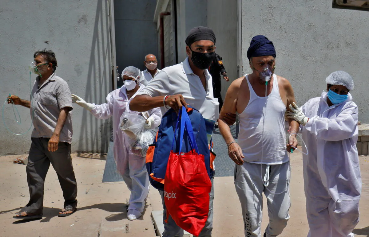 Patients wearing oxygen masks are shifted to a hospital in Ahmedabad, India, on April 21, 2021. (Amit Dave/Reuters)