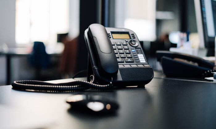 Phone on a black desk.
(Julian Hochgesang/ Unplash)