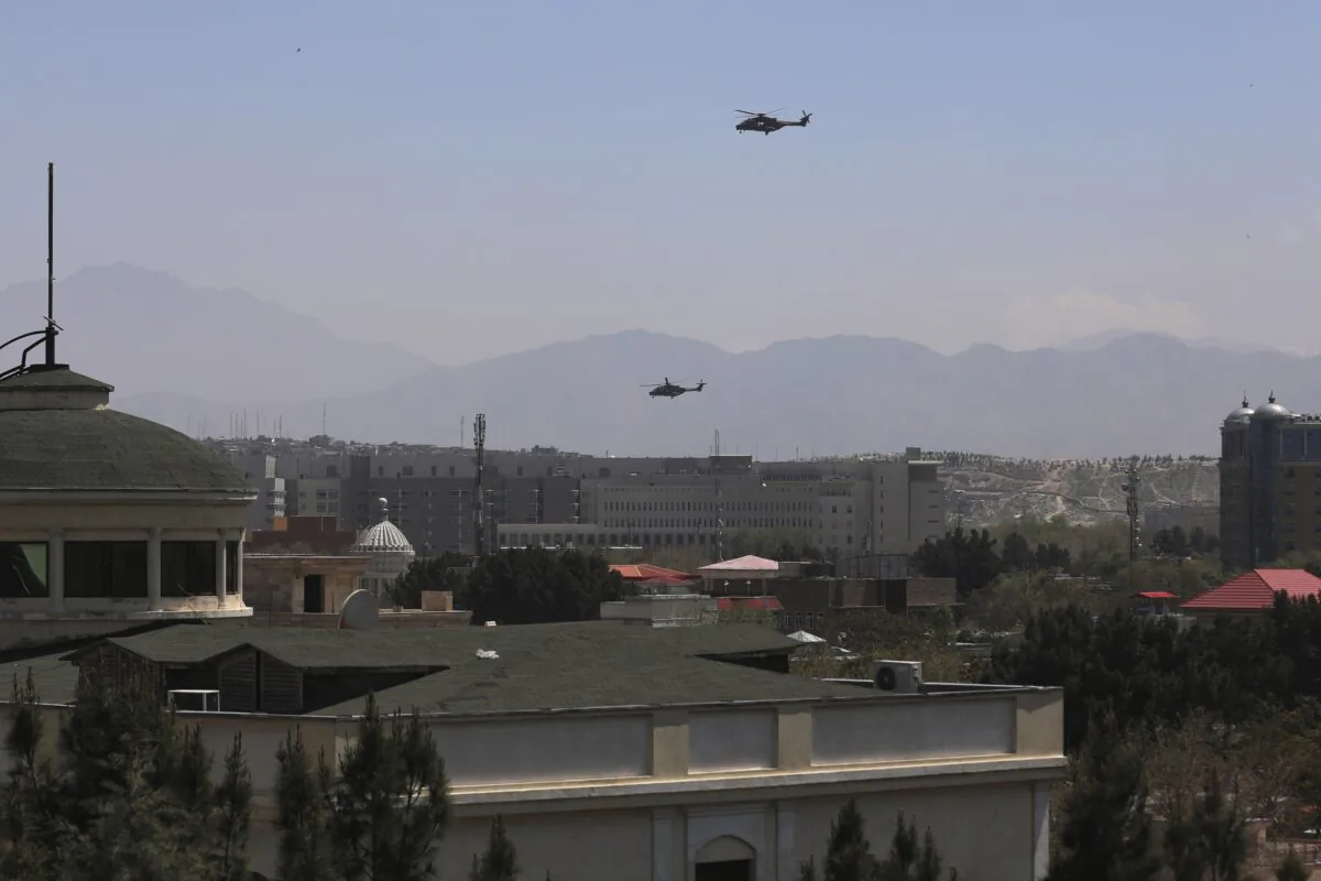 U.S. Black Hawk military helicopters fly over the city of Kabul, Afghanistan, on April 19, 2021. (Rahmat Gul/AP Photo)