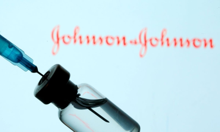 A vial and syringe are seen in front of a displayed Johnson & Johnson logo in this illustration taken Jan. 11, 2021. (Dado Ruvic/Reuters)