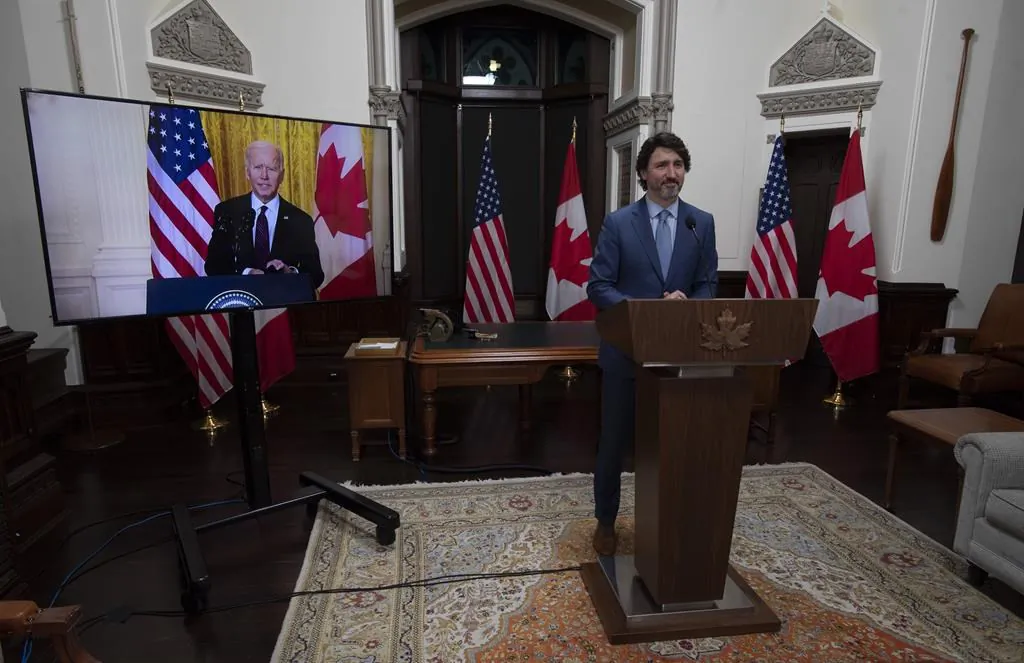 Canadian Prime Minister Justin Trudeau looks at United States President Joe Biden as he delivers a statement during a virtual joint statement in Ottawa, on February 23, 2021. (THE CANADIAN PRESS/Adrian Wyld)