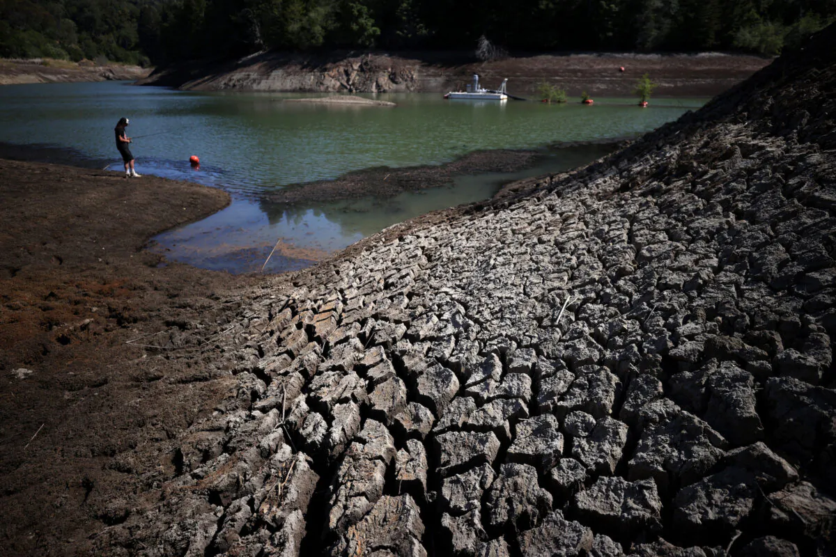 Dry cracked earth along the banks of Phoenix Lake in Ross, Calif., on April 21, 2021. (Justin Sullivan/Getty Images)