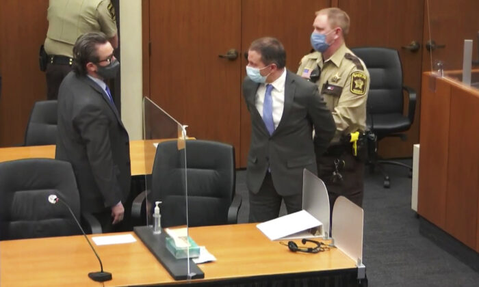 In this image from video, former Minneapolis police officer Derek Chauvin, center, is handcuffed as his lawyer Eric Nelson, left, watches, following the jury convicting Chauvin of three counts in the murder of George Floyd, in Hennepin County, Minn., on April 20, 2021. (Court TV via AP/Pool)