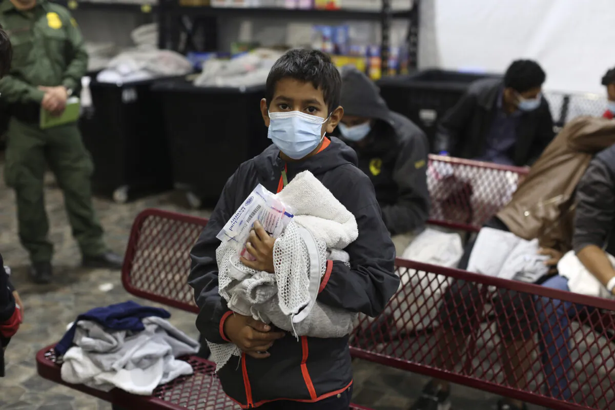 A young migrant waits for his turn to take a shower at the Department of Homeland Security holding facility in Donna, Texas, on March 30, 2021. (Dario Lopez-Mills/Pool/Getty Images)