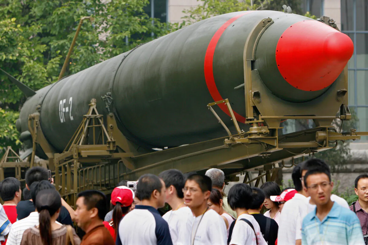 Visitors walk past China's second nuclear missile on display as they visit the Military Museum in Beijing on July 23, 2007. (Teh Eng-koon/AFP via Getty Images)