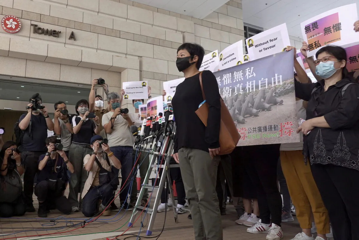 Bao Choy Yuk-Ling, a freelance journalist with RTHK, poses for pictures outside West Kowloon Magistrates' Courts as she arrives for charges of making a false statement to obtain data for a documentary on the police's handling of a mob attack, in Hong Kong, China, on April 22, 2021. (Pak Yiu/Reuters)