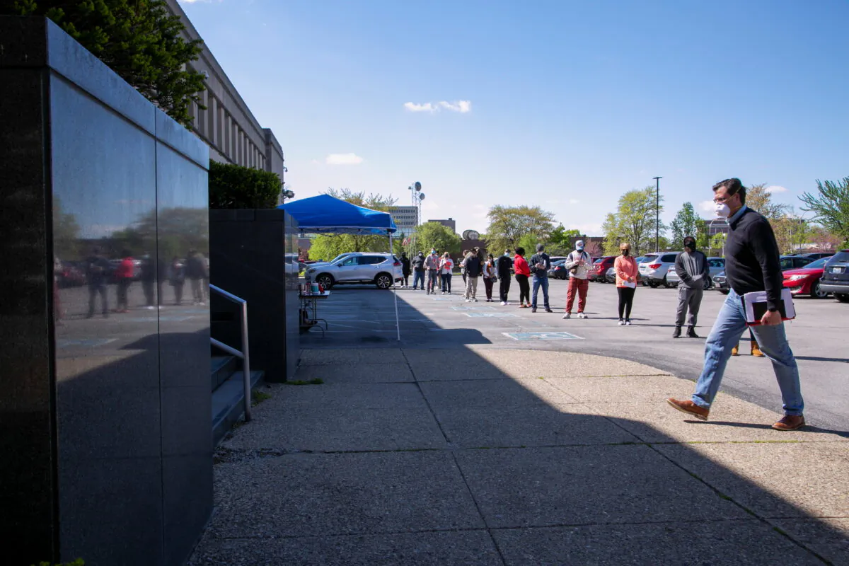 People line up outside a newly reopened career center for in-person appointments in Louisville, Ky., on April 15, 2021. (Amira Karaoud/Reuters)