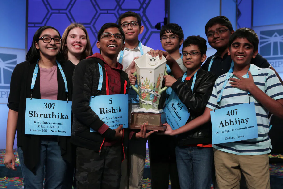 Co-champions (L-R) Shruthika Padhy (307) of Cherry Hill, N.J., Erin Howard (93) of Huntsville, Ala., Rishik Gandhasri (5) of San Jose, Calif., Christopher Serrao (427) of Whitehouse Station, N.J., Saketh Sundar (132) of Clarksville, Md., Sohum Sukhatankar (354) of Dallas, Texas, Rohan Raja (462) of Irving, Texas, and Abhijay Kodali (407) of Flower Mound, Texas, hold the trophy for photographers after 20 rounds of competition and won the championship of the Scripps National Spelling Bee at the Gaylord National Resort & Convention Center May 31, 2019, in National Harbor, Md. The winning spellers made history with the most number of co-champions in the spelling event history. (Alex Wong/Getty Images)