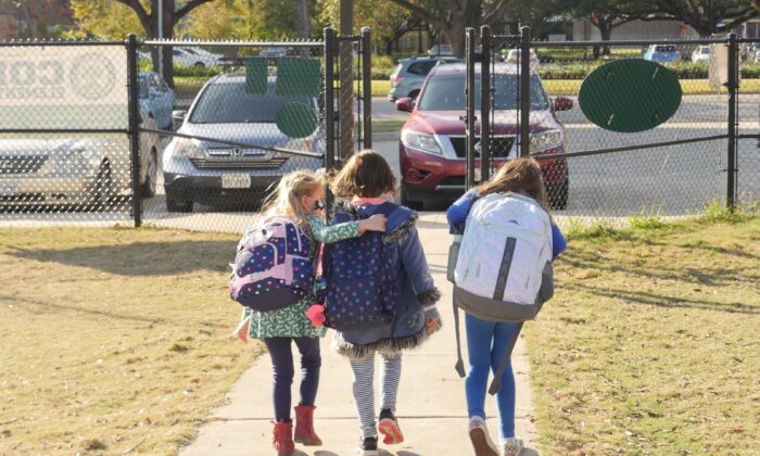 School children walk outside Condit Elementary School in Bellaire, outside Houston, Texas, on Dec. 16, 2020. (François Picard/AFP via Getty Images)
