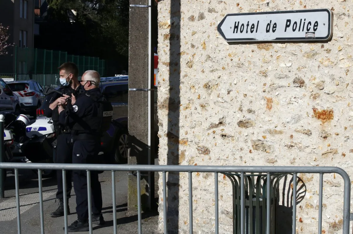 Police officers block the access next to the Police station in Rambouillet, south west of Paris, on April 23, 2021, after a 49-year-old female officer was stabbed to death inside the station by an Islamic extremist, who was shot and killed by police at the scene. (AP Photo/Michel Euler)