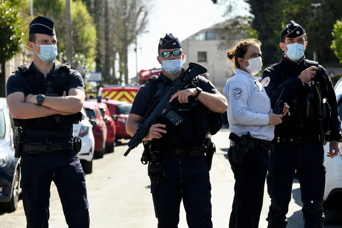 French police officials block off a street after a female police employee was stabbed to death by a Tunisian man at a police station in Rambouillet, southwest of Paris, on April 23, 2021. (Bertrand Guay/AFP via Getty Images)