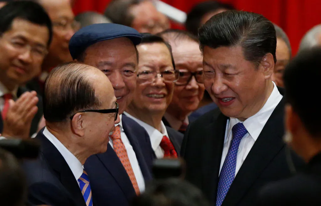 China's President Xi Jinping (R) is greeted by Hong Kong tycoon Li Ka-shing (L) before a photo session during Xi's visit in Hong Kong on June 30, 2017. (BOBBY YIP/AFP via Getty Images)