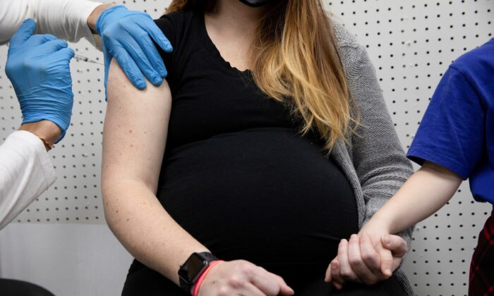 A pregnant woman receives a vaccine for COVID-19 in Schwenksville, Pa., on Feb. 11, 2021. (Hannah Beier/Reuters)