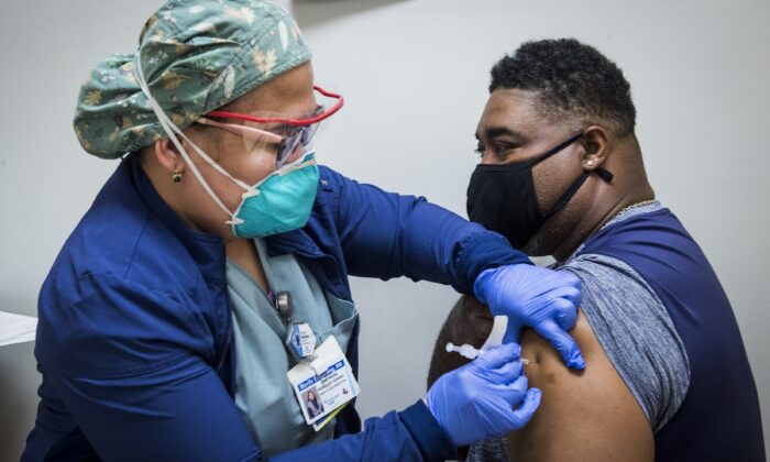 A nurse administers a COVID-19 vaccine to a man in Houston, Texas, on Feb. 11, 2021. (Brett Coomer/Houston Chronicle via AP)
