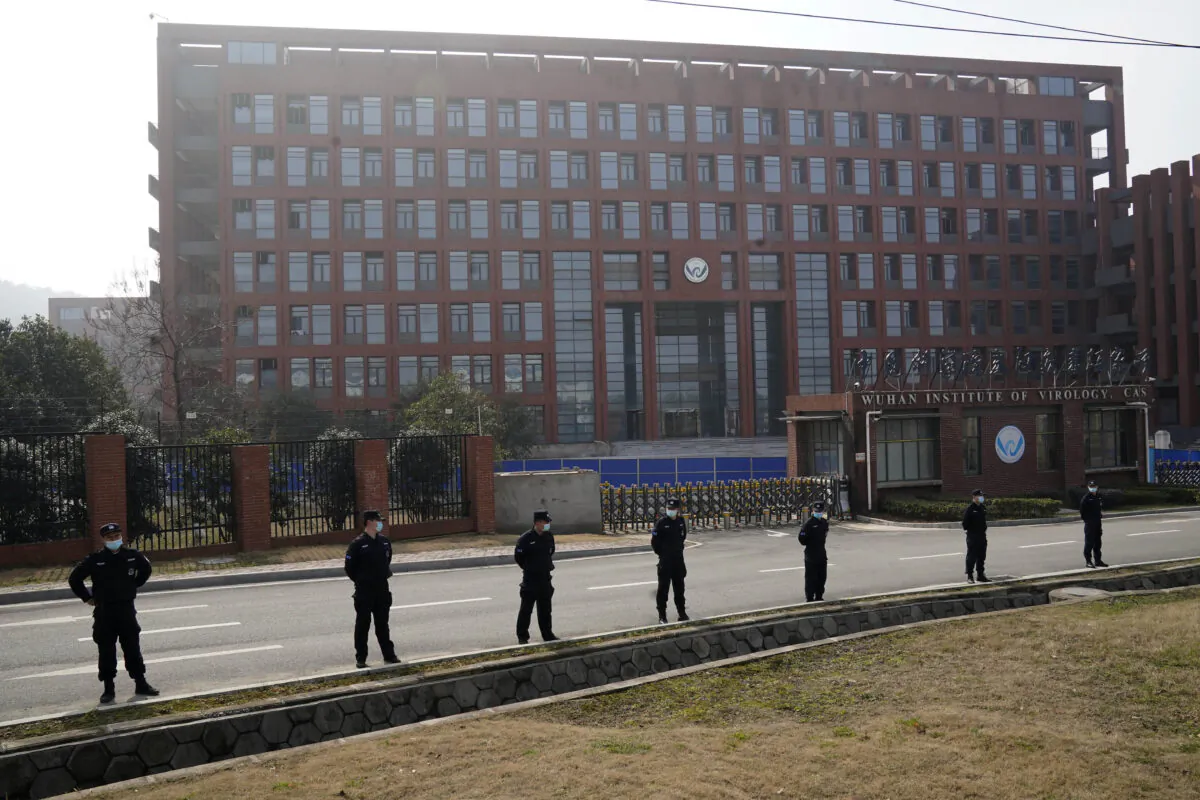 Security personnel stand guard as members of the World Health Organization team investigating the origins of the COVID-19 make a visit to the Wuhan Institute of Virology in Wuhan, China, on Feb. 3, 2021. (Ng Han Guan/AP Photo)