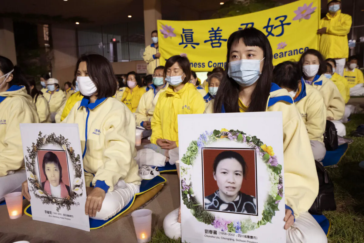 Falun Dafa practitioners hold photos of some of those who were killed during the 22-year persecution by the Chinese Communist Party in China, at a candlelight vigil in Los Angeles on April 23, 2021. (Debora Cheng/The Epoch Times)