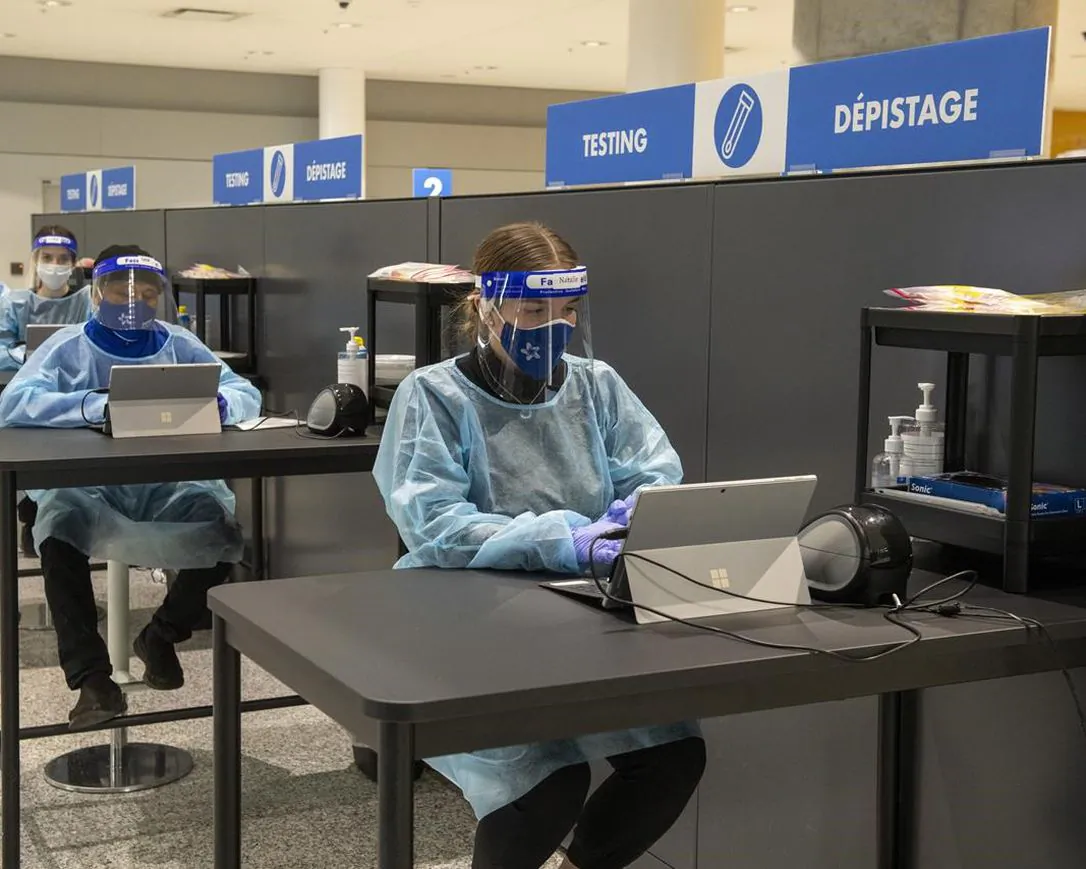 Workers prepare to greet passengers at the COVID-19 testing centre in the International Arrivals area at Pearson Airport in Toronto on January 26, 2021. (Frank Gunn/The Canadian Press)