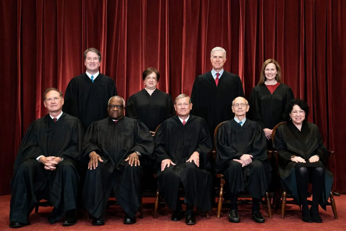 Seated from left: Associate Justice Samuel Alito, Associate Justice Clarence Thomas, Chief Justice John Roberts, Associate Justice Stephen Breyer, and Associate Justice Sonia Sotomayor, standing from left: Associate Justice Brett Kavanaugh, Associate Justice Elena Kagan, Associate Justice Neil Gorsuch, and Associate Justice Amy Coney Barrett pose during a group photo of the Justices at the Supreme Court in Washington on April 23, 2021. (Erin Schaff/Pool/AFP via Getty Images)
