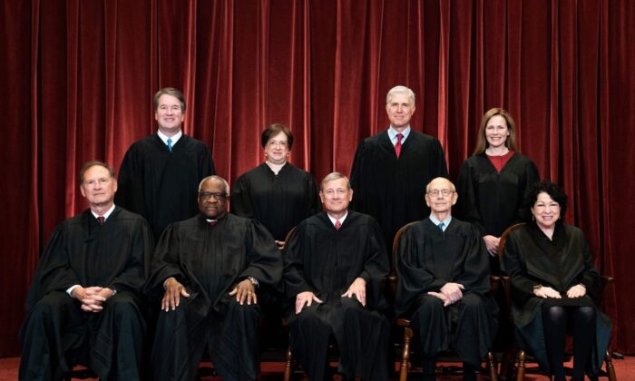 Seated from left: Associate Justice Samuel Alito, Associate Justice Clarence Thomas, Chief Justice John Roberts, Associate Justice Stephen Breyer, and Associate Justice Sonia Sotomayor, standing from left: Associate Justice Brett Kavanaugh, Associate Justice Elena Kagan, Associate Justice Neil Gorsuch, and Associate Justice Amy Coney Barrett pose during a group photo of the Justices at the Supreme Court in Washington on April 23, 2021. (Erin Schaff/Pool/AFP via Getty Images)