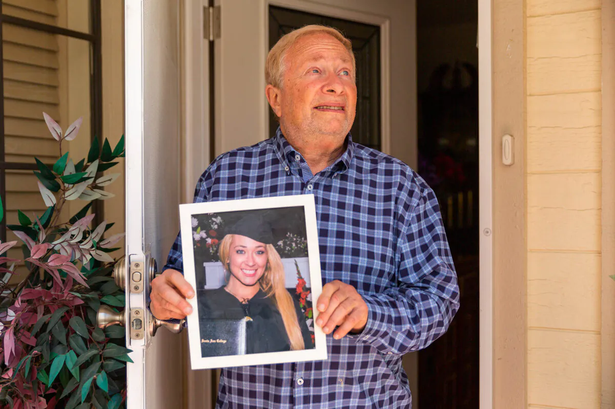 Moley Grossman holds a photo of his daughter, Lili, 36, who has been missing for two weeks. He is pictured in Mission Viejo, Calif., on April 26, 2021. (John Fredricks/The Epoch Times)