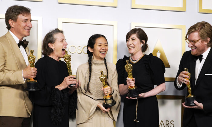 From left, Peter Spears, Frances McDormand, Chloe Zhao, Mollye Asher and Dan Janvey, winners of the award for best picture for "Nomadland," pose in the press room at the Oscars at Union Station in Los Angeles on April 25, 2021. (Chris Pizzello, Pool/AP)

