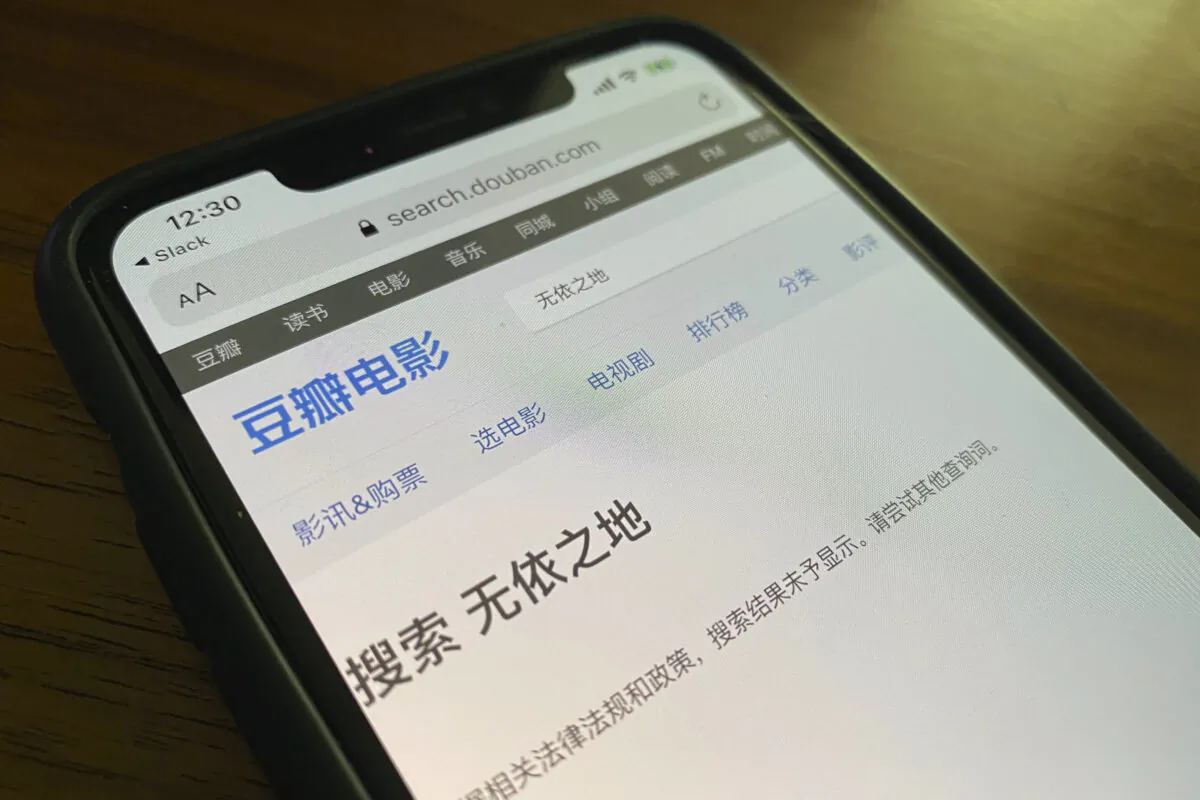 A phone shows a search page from Douban for Nomadland resulting in the message “the search results could not be displayed in accordance to relevant laws and regulations,” in Beijing on April 26, 2021. (Ng Han Guan/AP Photo)