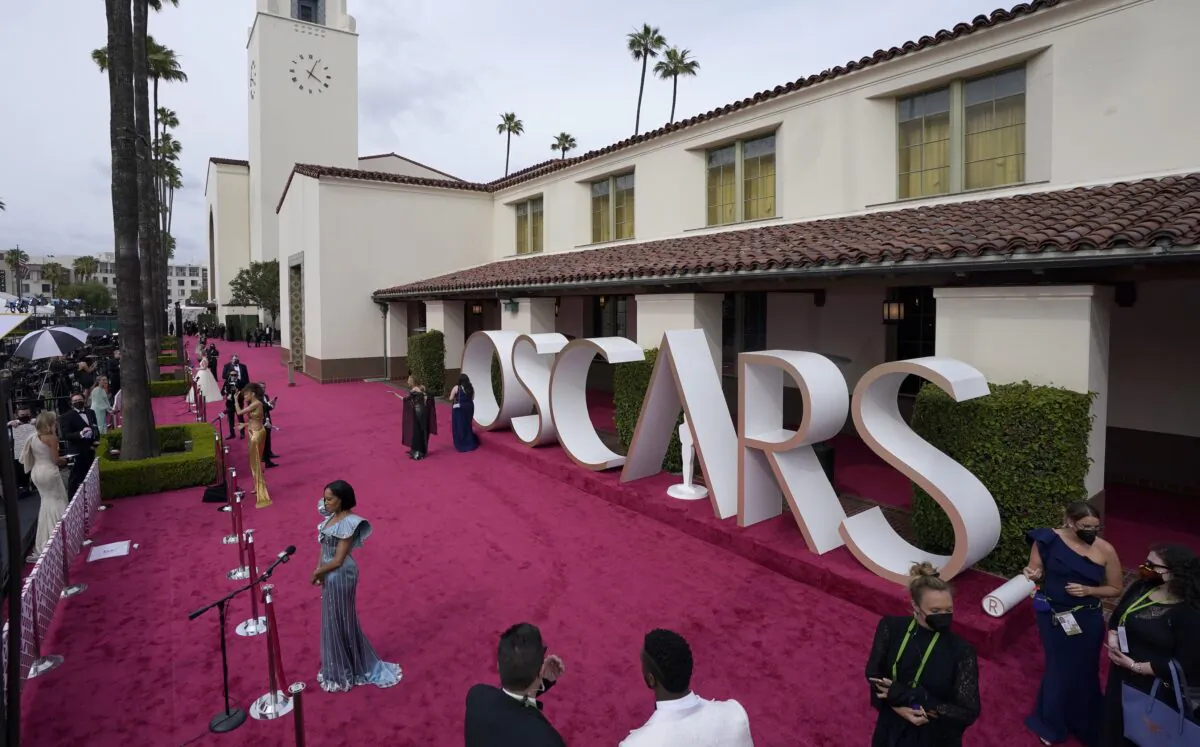 Maria Bakalova, from left, Andra Day and Regina King are interviewed and Marlee Matlin walks the red carpet at the Oscars at Union Station in Los Angeles, Calif., on April 25, 2021. (Mark Terrill/AP Photo)