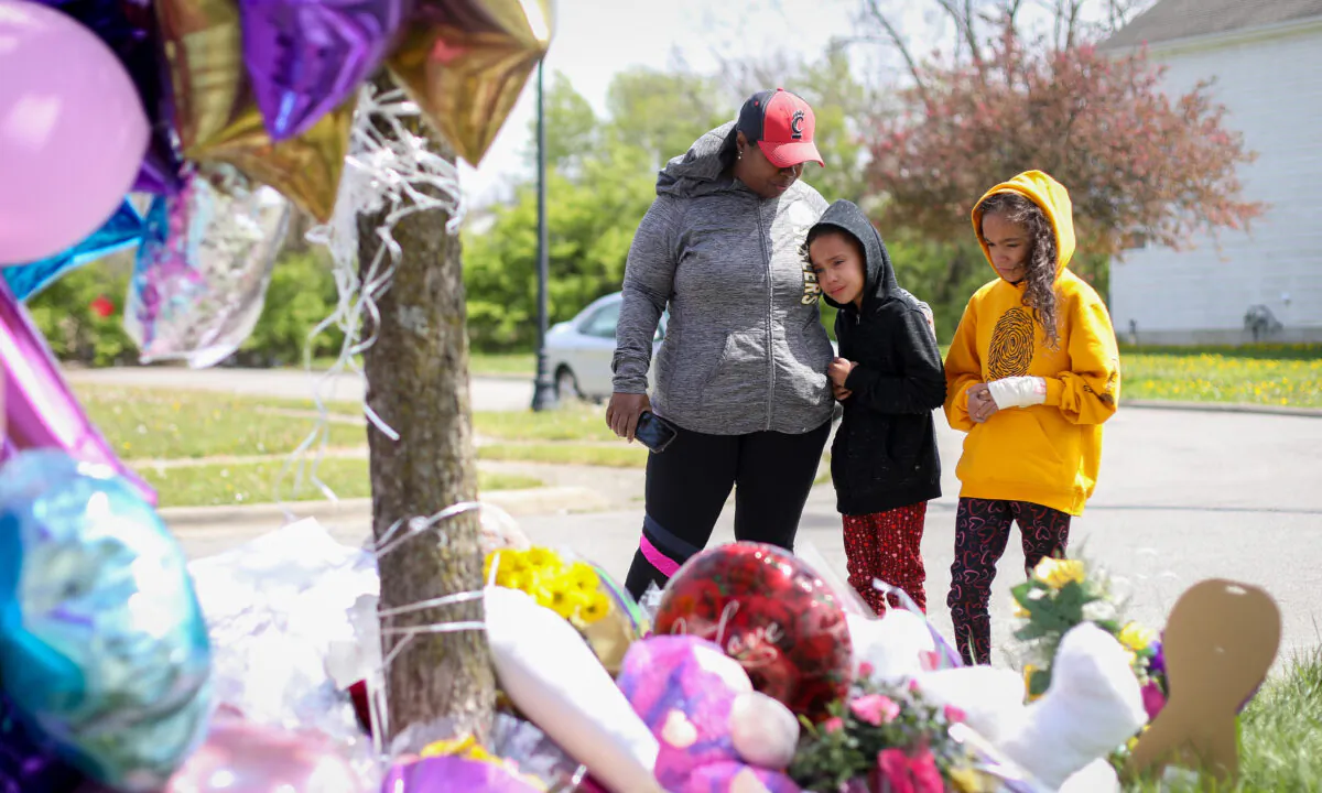 People at a memorial for Ma'Khia Bryant on Legion Lane, where a police officer shot the 16-year-old girl as she was attacking a woman with a knife, in Columbus, Ohio, on April 23, 2021. (Samira Bouaou/The Epoch Times)
