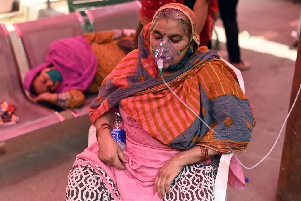 A patient breathes with the help of oxygen provided by a gurdwara, a place of worship for Sikhs, under a tent installed along the roadside amid the COVID-19 pandemic in Ghaziabad, India, on April 26, 2021. (Sajjad Hussain/Getty Images)