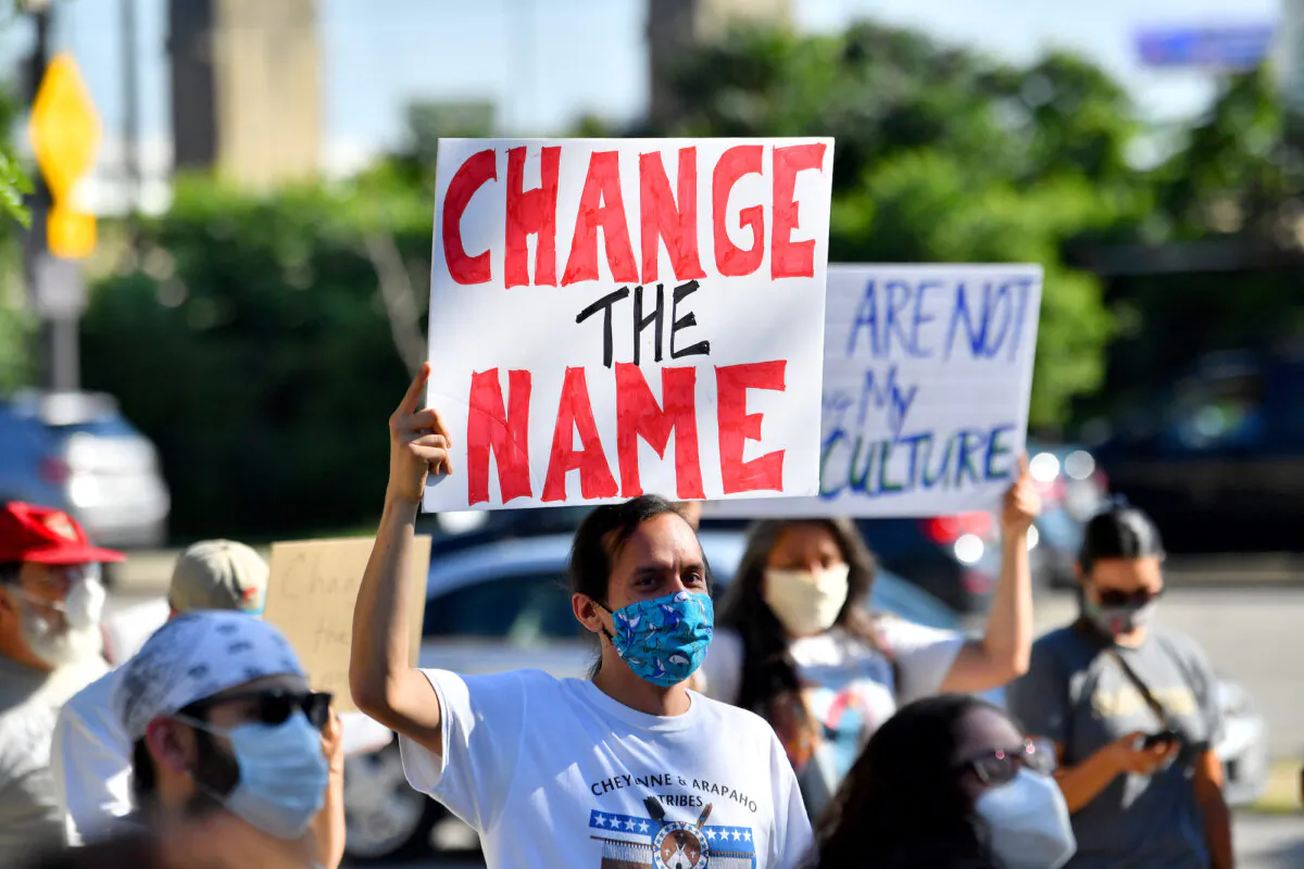 A group of protesters demonstrate against the Cleveland Indians mascot prior to the Opening Day game between the Cleveland Indians and the Kansas City Royals in Cleveland, Ohio. on July 24, 2020. (Jason Miller/Getty Images)