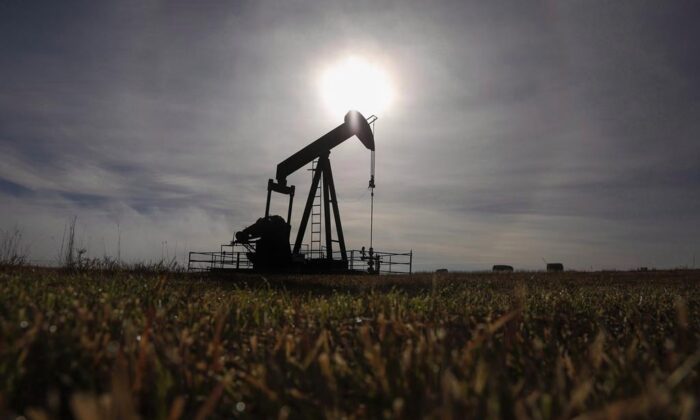 A pumpjack works at a well head on an oil and gas installation near Cremona, Alta., on Oct. 29, 2016. (Jeff McIntosh/The Canadian Press)