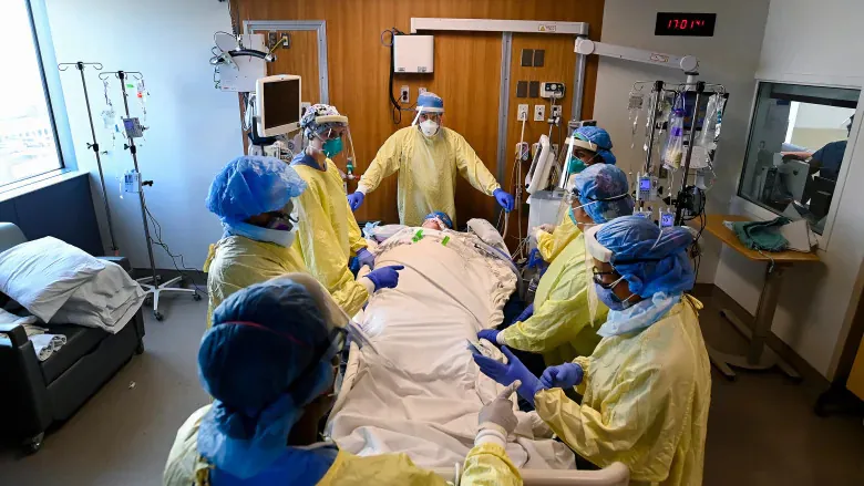 Health-care staff get ready to prone a woman, 47, who has COVID-19 and is intubated on a ventilator in the intensive care unit at the Humber River Hospital during the COVID-19 pandemic earlier this month in Toronto. (Nathan Denette/The Canadian Press)