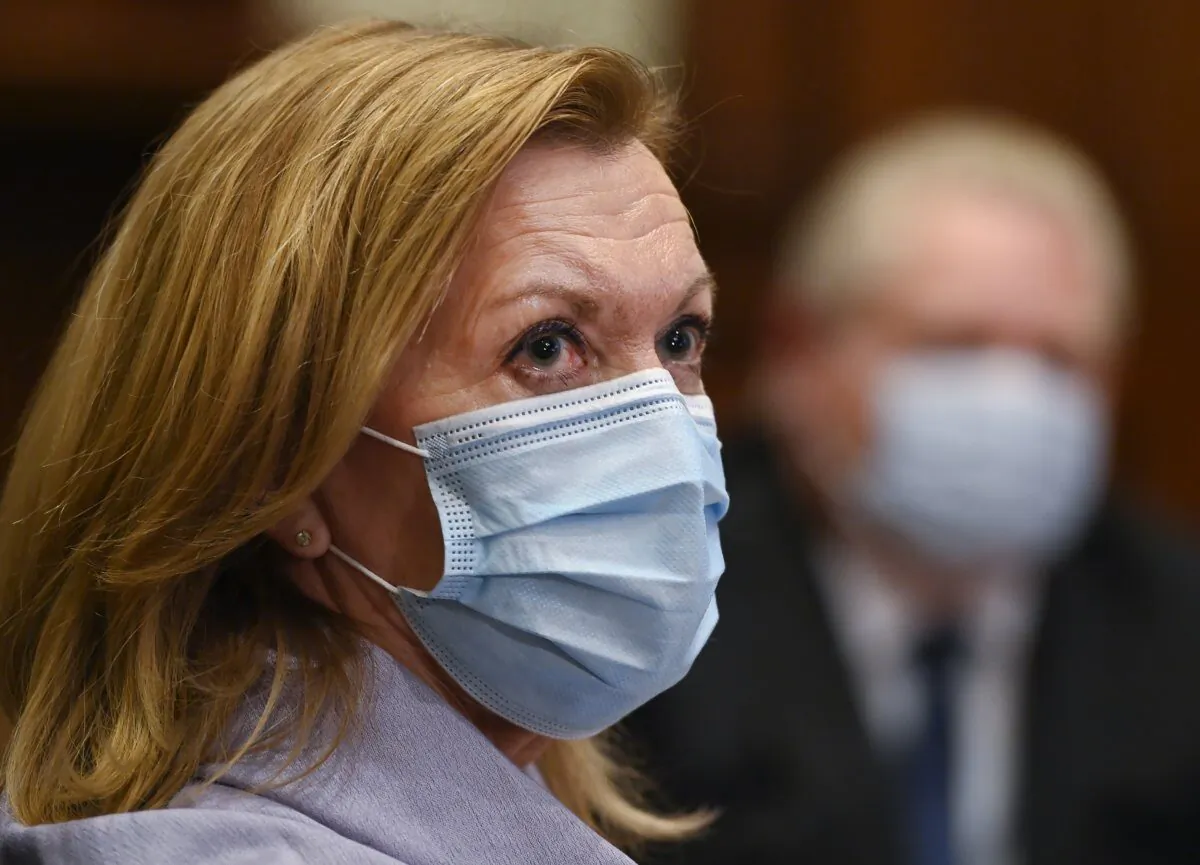 Ontario Health Minister Christine Elliott listens as Ontario Premier Doug Ford gives an update regarding the Ontario COVID-19 vaccine in Toronto on January 5, 2021. Ontario says hospitals will be able to transfer patients waiting for a long-term care bed to any nursing home without their consent. (Nathan Denette/The Canadian Press)