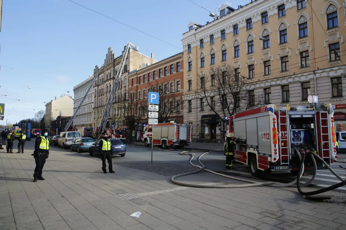 Firefighters and rescuers from the  Latvian State Fire and Rescue Service work at the site of a fire, in Riga, Latvia, on April 28, 2021. (Kaspars Krafts/F64 Photo agency via AP)