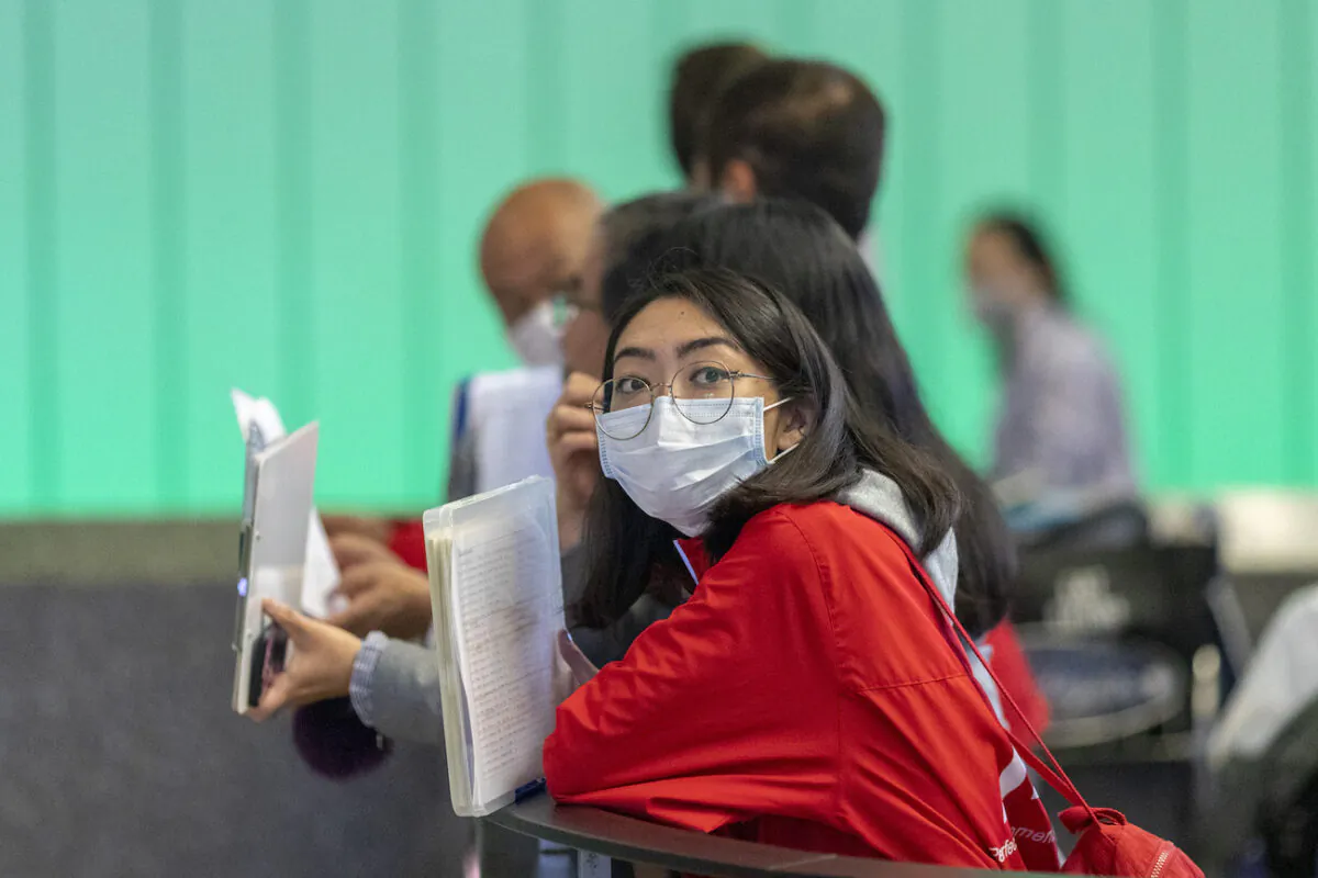 A woman waits for an international traveler to arrive to LAX Tom Bradley International Terminal in Los Angeles, Calif., on Feb. 2, 2020. (David McNew/Getty Images)