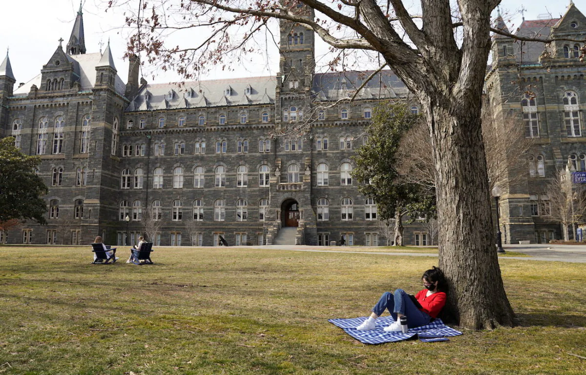 A student studies in the sunshine at Georgetown University in Washington, on March 9, 2021. (Kevin Lamarque/Reuters)
